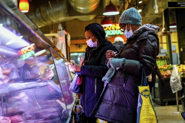 Customers shop at the Reading Terminal Market in Philadelphia on Feb. 16, 2022.