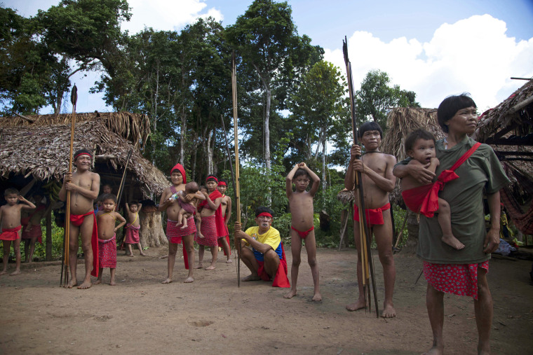 Yanomami Indians stand at their village called Irotatheri in Venezuela's Amazon region, on Sept. 7, 2012.