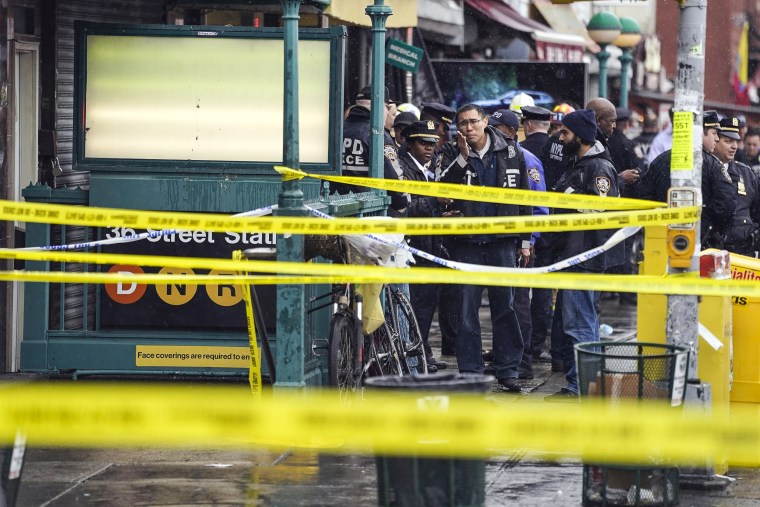 Image: New York City Police Department personnel gather at the entrance to a subway stop in the Brooklyn, N.Y., on April 12, 2022