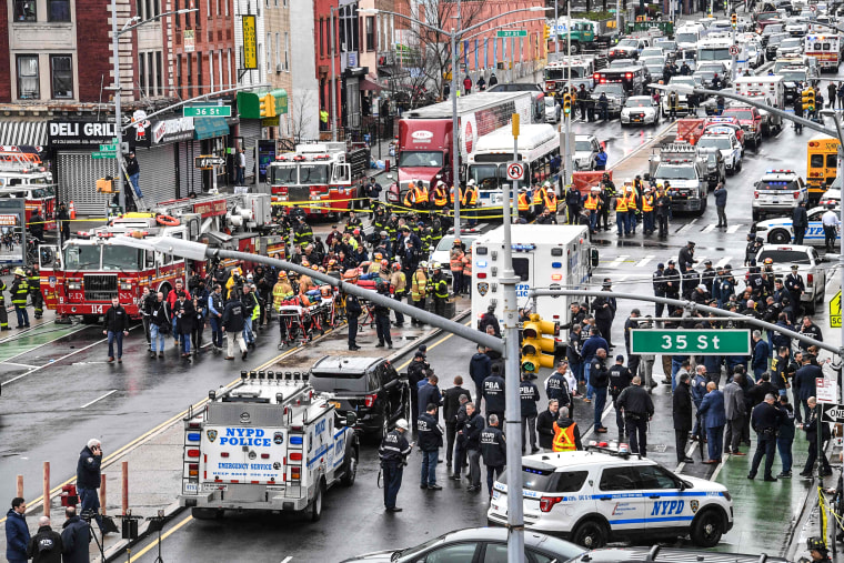 Image: Members of the New York Police Department and emergency vehicles line the streets following a rush hour shooting at a subway station in Brooklyn, NY, on April 12, 2022 .