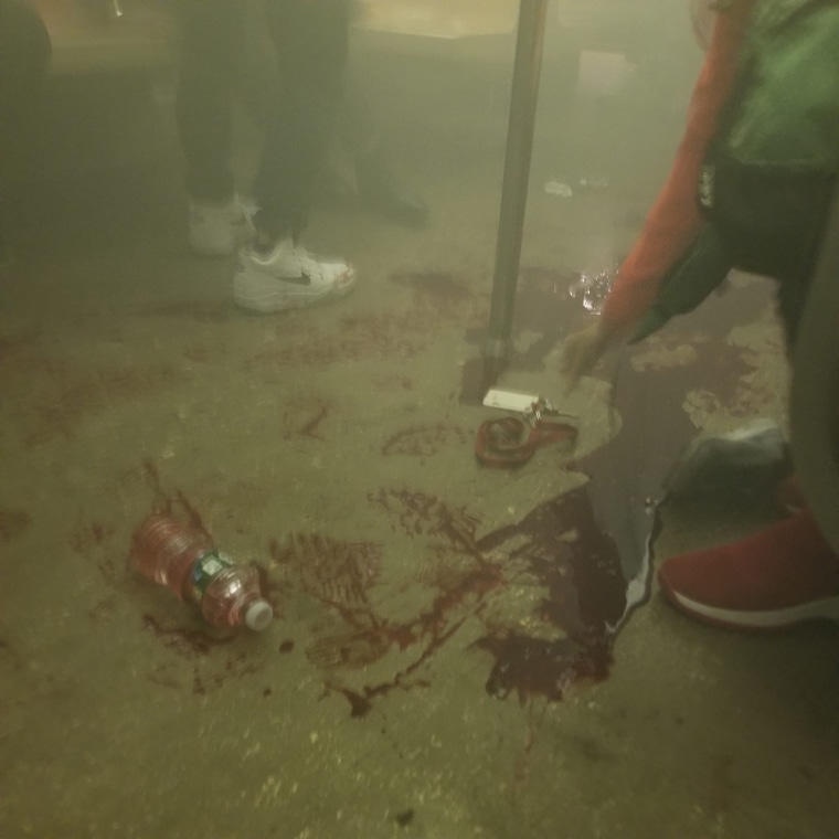 Blood on the ground of a subway car.
