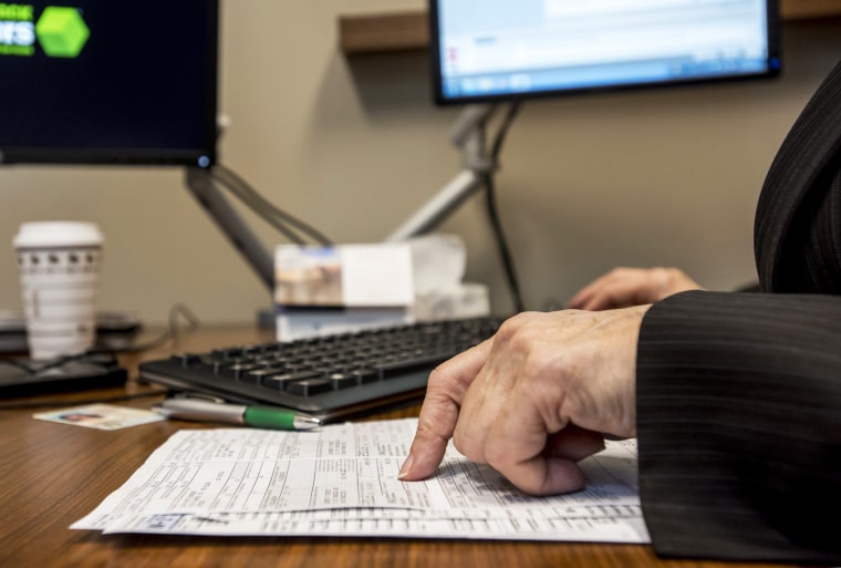 A tax advisor looks over paperwork