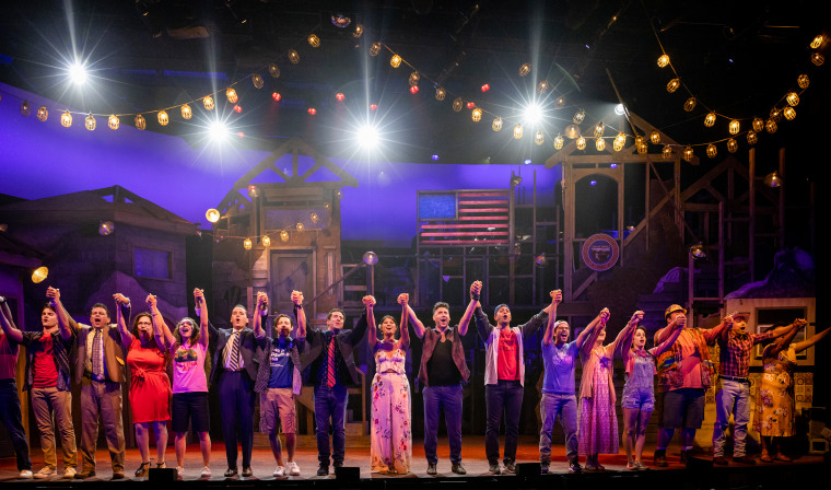 The cast of the Off-Broadway play "Americano" bows at the end of a performance.