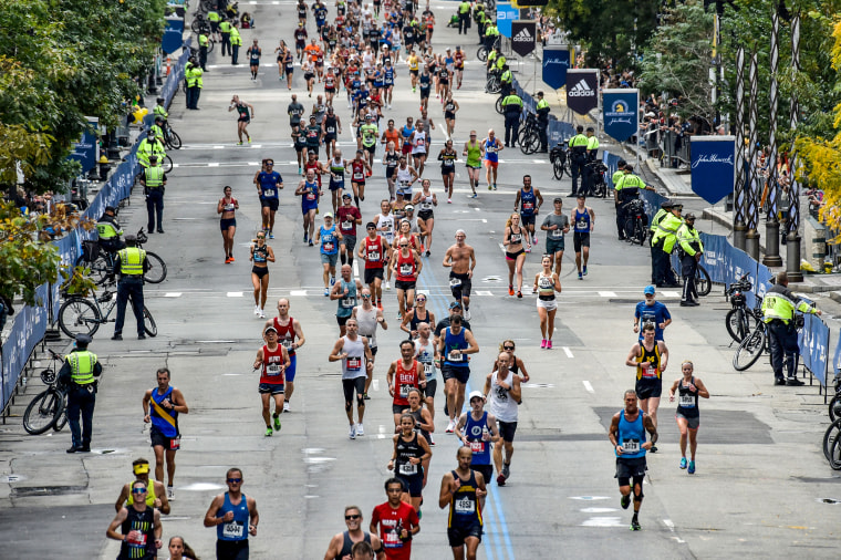 Runners make their way to the finish line down Boylston Street during the 125th Boston Marathon on Oct. 11, 2021.