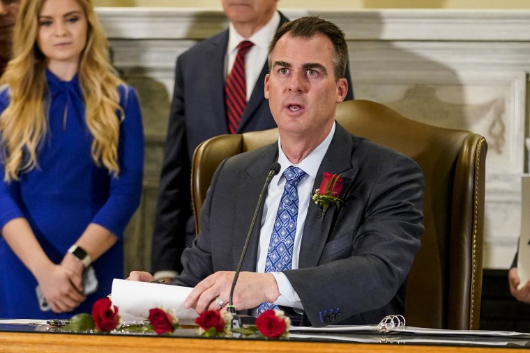 Oklahoma Gov. Kevin Stitt signs into law a bill making it a felony to perform an abortion, punishable by up to 10 years in prison, on April 12, 2022, in Oklahoma City.
