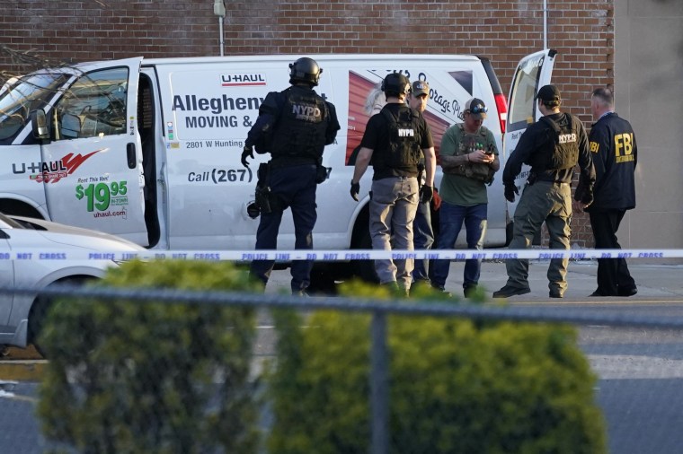 Image: Emergency personnel including the FBI search a moving truck