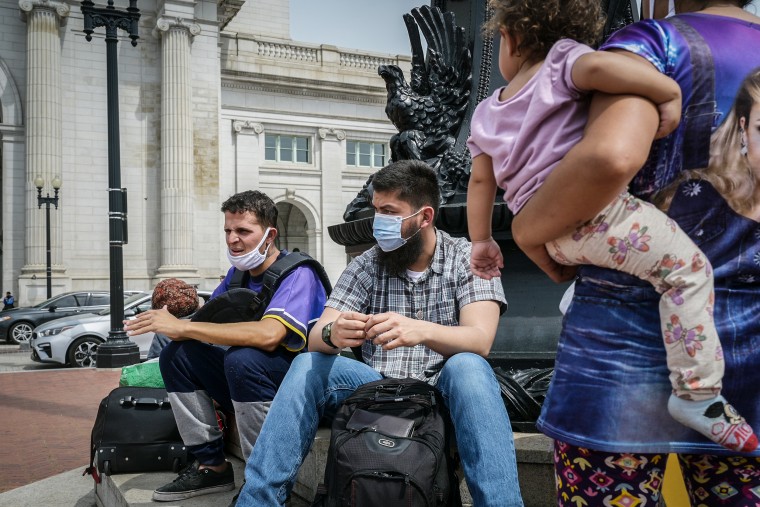 Migrants being carried on buses from Texas are seen outside Union Station in Washington, DC, on April 13, 2022.