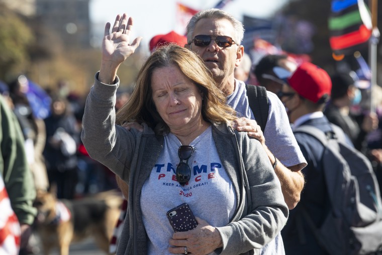 Trump supporters pray at Freedom Plaza during the Million MAGA March in Washington on Nov. 14, 2020.