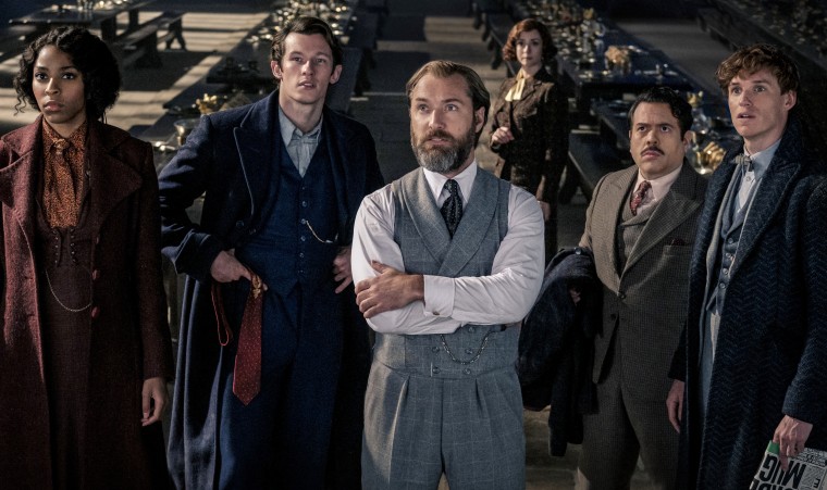 From left: Jessica Williams, Callum Turner, Jude Law, Fiona Glascott, Dan Fogler and Eddie Redmayne in "Fantastic Beasts: The Secrets of Dumbledore."