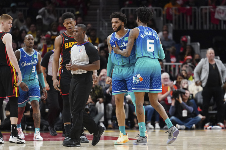 Charlotte Hornets forward Miles Bridges is restrained by guard Jalen McDaniels as he argues a foul call in the second half of an NBA play-in basketball game against the Atlanta Hawks on April 13, 2022, in Atlanta.