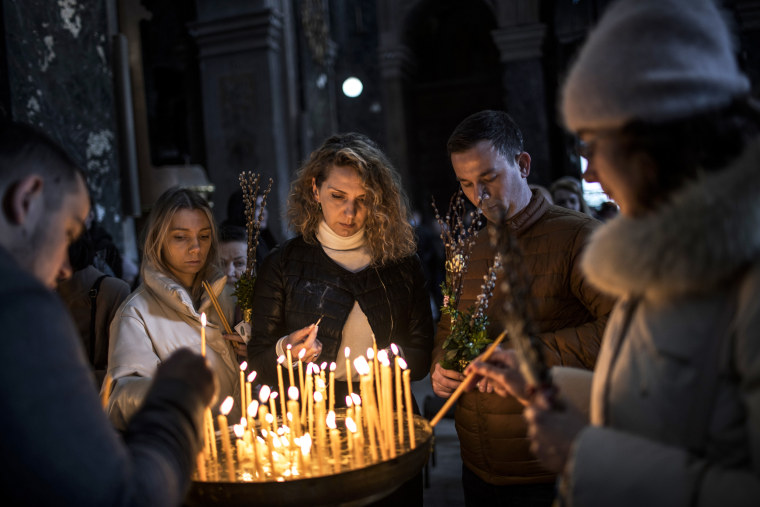 Worshippers gather to attend a mass at Church of the Most Holy Apostles Peter and Paul in Lviv, Ukraine, on April 17, 2022.