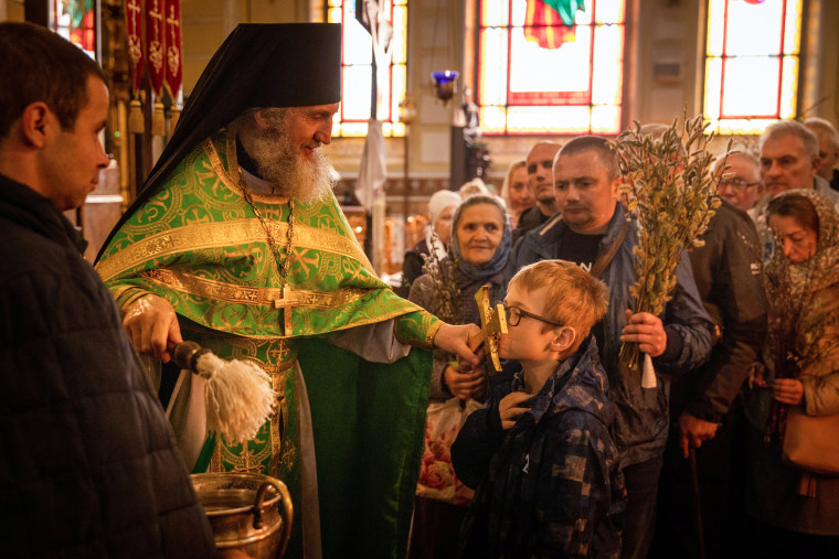 People attend a Palm Sunday church service on April 17, 2022, in Kharkiv, Ukraine.