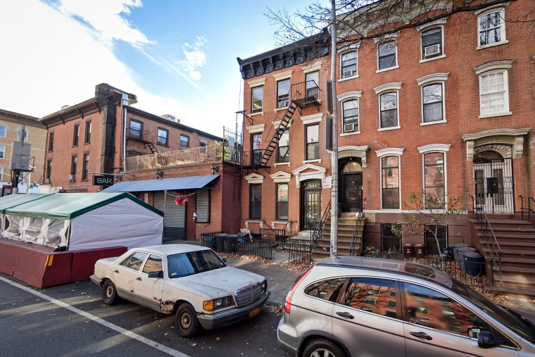 Police were called to a townhouse, center, in Park Slope, Brooklyn, to help an unconscious infant in November 2021.