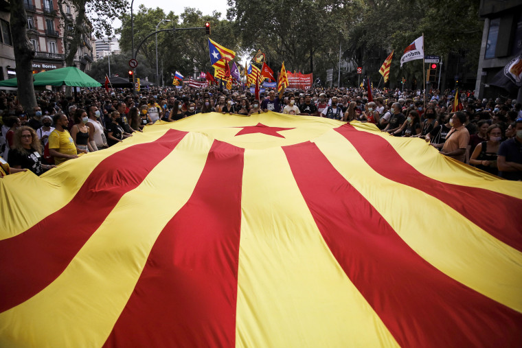 People hold an Estelada flag during a demonstration organized by the Independence Left on Sept. 11, 2021, in Barcelona, Catalonia, Spain.