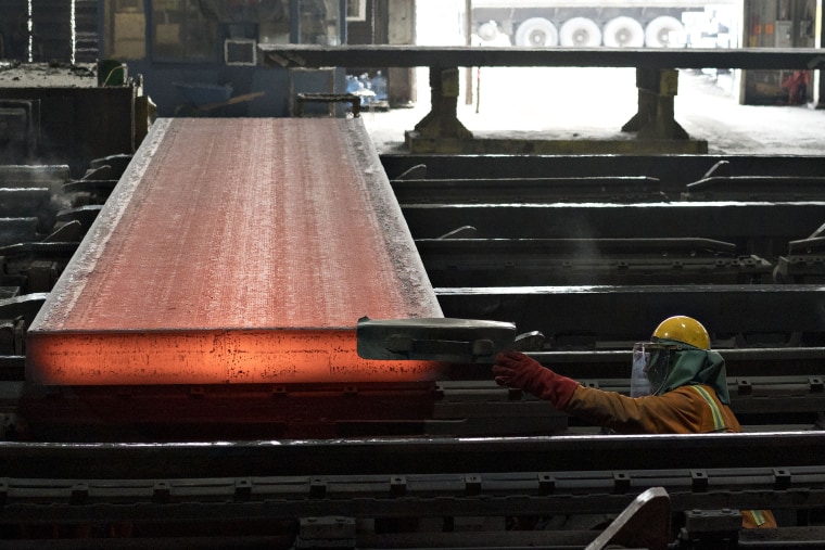 Image:  An employee inspects a steel slab during production at the NLMK Indiana facility in Portage, Ind., on April 13, 2018.
