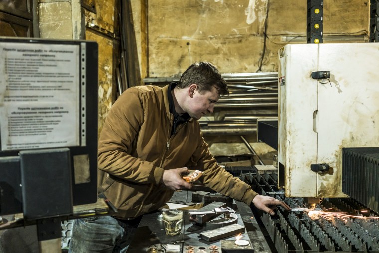Maksim Karpo operates machinery at Metal Workshop on April 16, 2022, in Lviv, Ukraine.