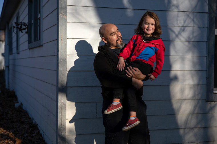 Pedro Rios and his son, Felix Bell-Rios, 4, outside their home in Weed, Calif., on Feb. 23, 2021. 