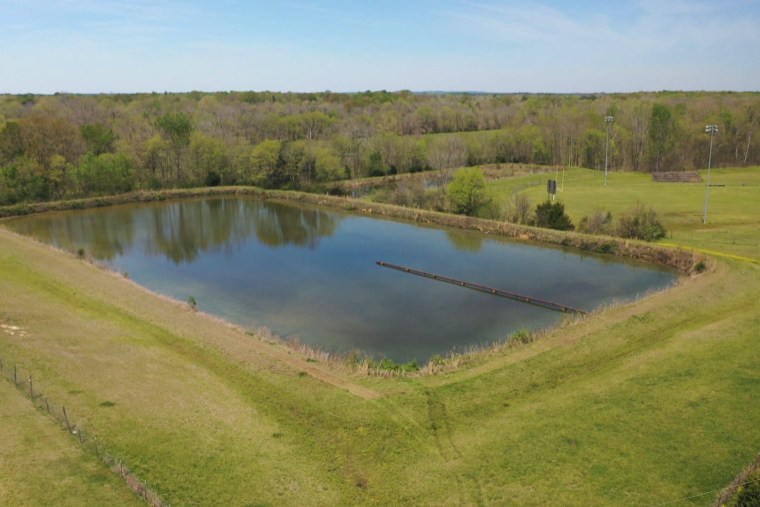 Dark green water across from a home in Lowndes County, Ala., holds a foul-smelling mix of human waste.