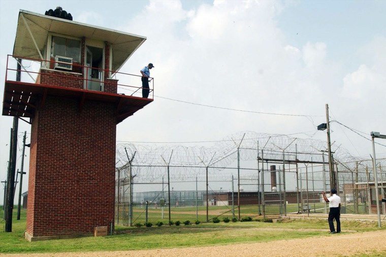 Guards patrol the perimeter fence at Mississippi State Penitentiary, also known as Parchman. A two-year federal probe into the facility found that unsafe prison conditions violated the U.S. Constitution.