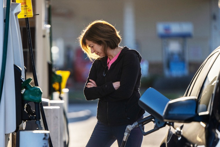 A person pumps gas
