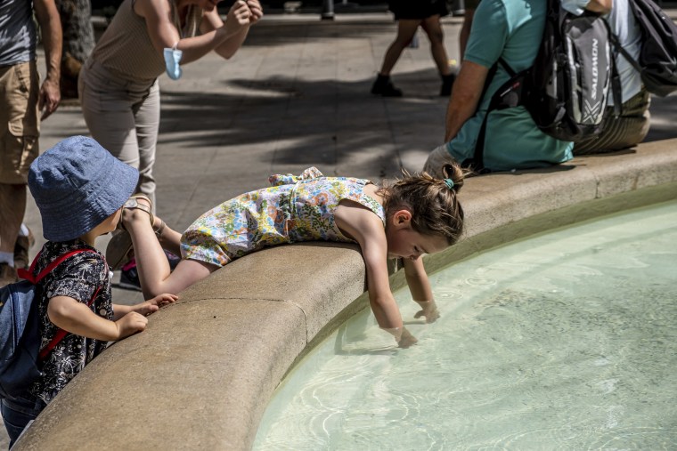 A kid cools off in the public fountain in Plaça Reial, Barcelona on Aug. 12, 2021.