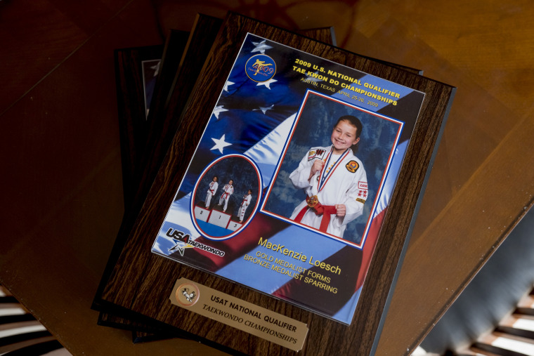 Taekwondo awards belonging to MacKenzie Loesch at her home gym in Marthasville, Mo.