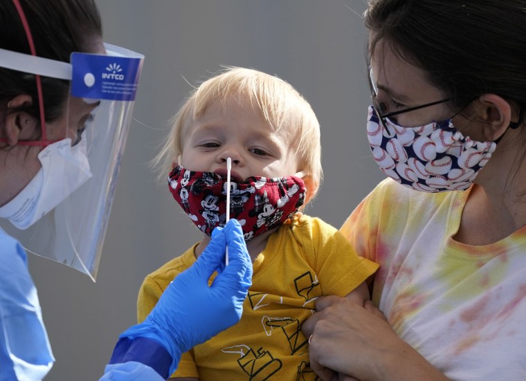 One-year-old Quentin Brown is held by his mother as he is tested for Covid-19 in Seattle on Aug. 28, 2020.