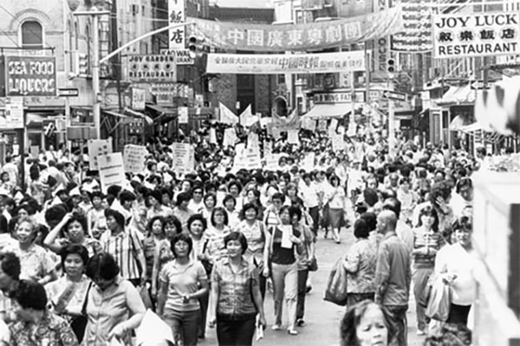 ILGWU members march through Chinatown to urge the remaining shops to sign the new contract, following the rally on July 15, 1982.