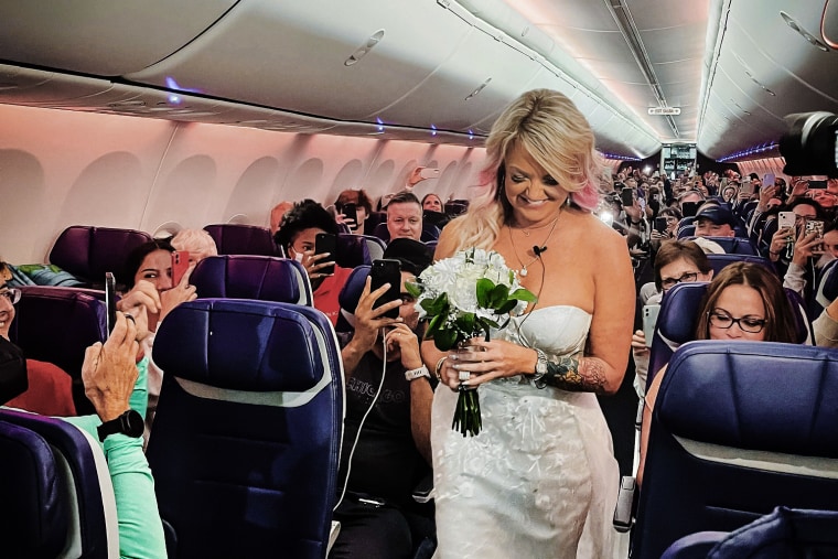 Pam walks down the aisle during her wedding ceremony on a Southwest Airlines flight.