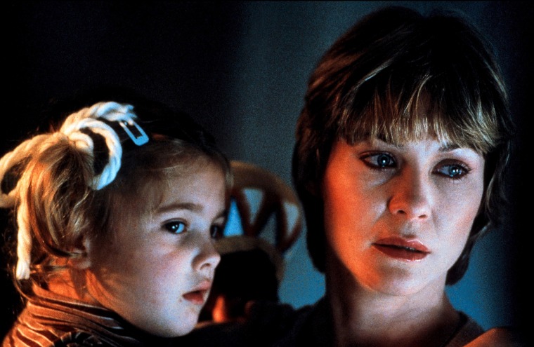 A young Drew Barrymore as Gertie is held by her on-screen mom, Dee Wallace, who played Mary Taylor in the film "E.T. the Extra Terrestrial."