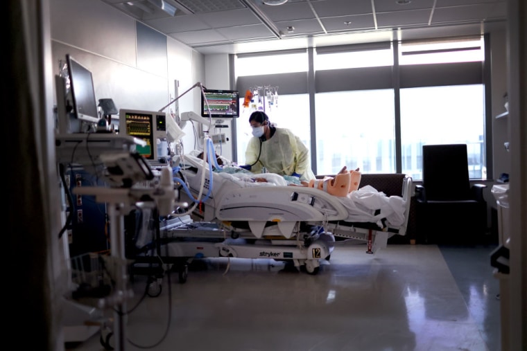 Una terapeuta respiratoria atiende a un paciente de COVID-19 en la UCI del hospital Rush University Medical Center el 31 de enero de 2022 en Chicago.