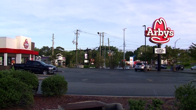 An Arby's restaurant from the outside with a sign.