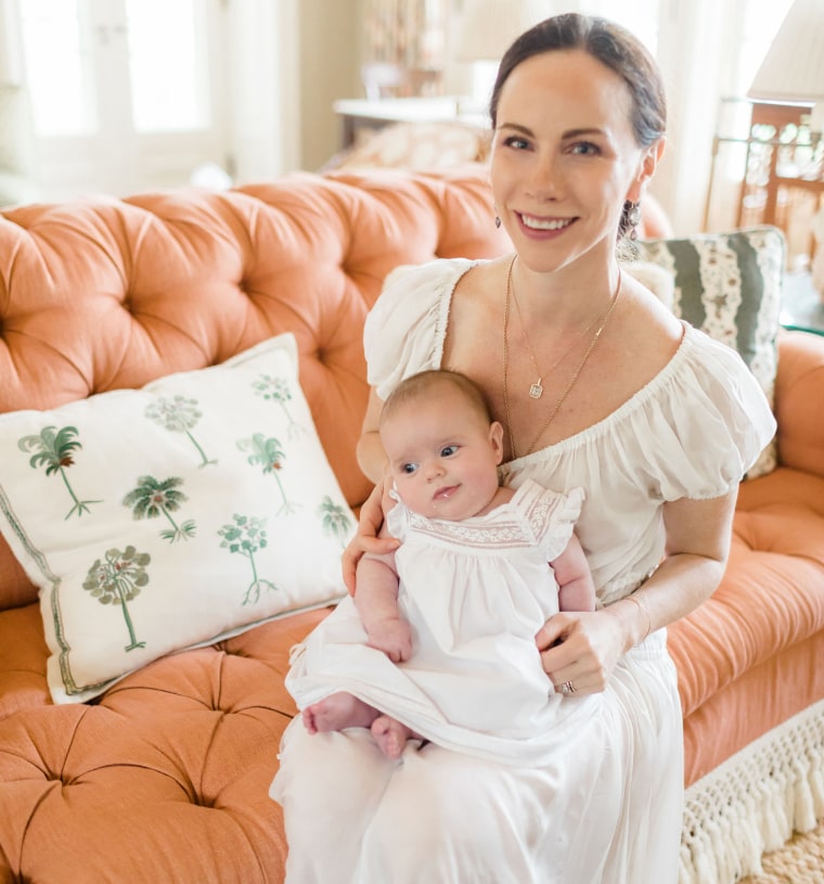 Barbara Bush and her baby girl, Cora Georgia, look like twins while wearing white dresses. 