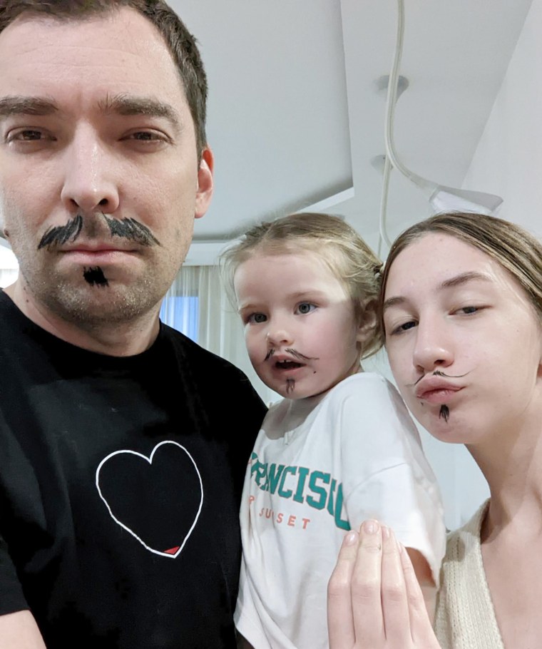 Igor Novikov, pictured with his two daughters, Masha and Sasha.