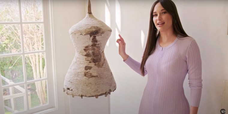 Kacey Musgraves shows a hornet's nest built around a basket that's on display in her living room while giving a tour of her Nashville home to Architectural Digest.