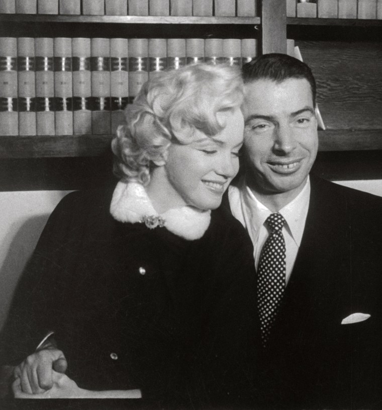 Marilyn Monroe and Joe DiMaggio Sitting Close Together