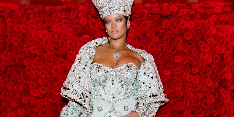 Rihanna posing at the 2018 Met Gala, themed "Heavenly Bodies."
