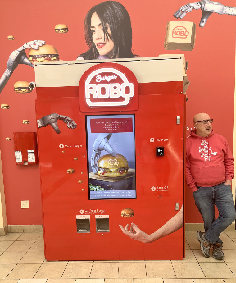 Andy Siegal, RoboBurger co-founder and CMO, stands next to the vending machine.