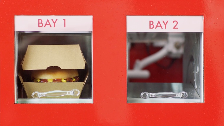 RoboBurger delivers your burger into one of two bays, where you pick it up.