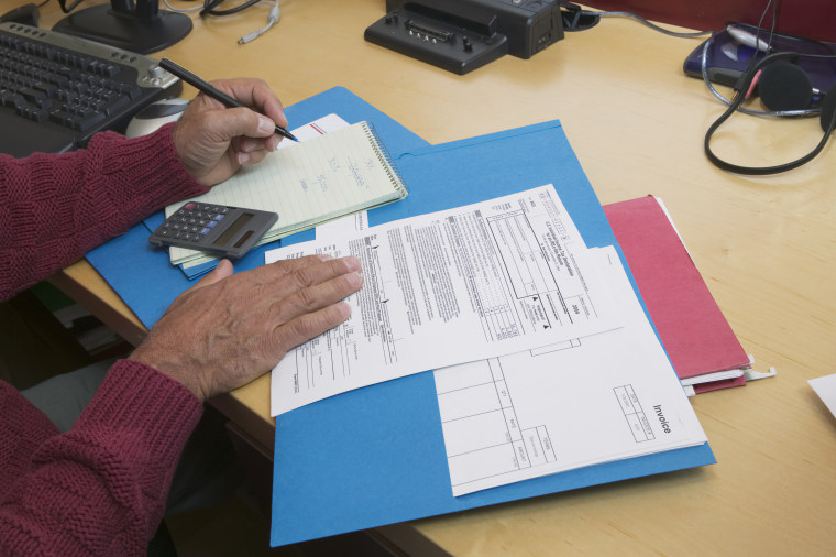 Mature man preparing tax forms, close-up