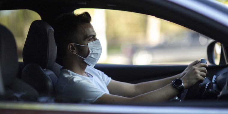 Portrait of driver wearing protective medical mask