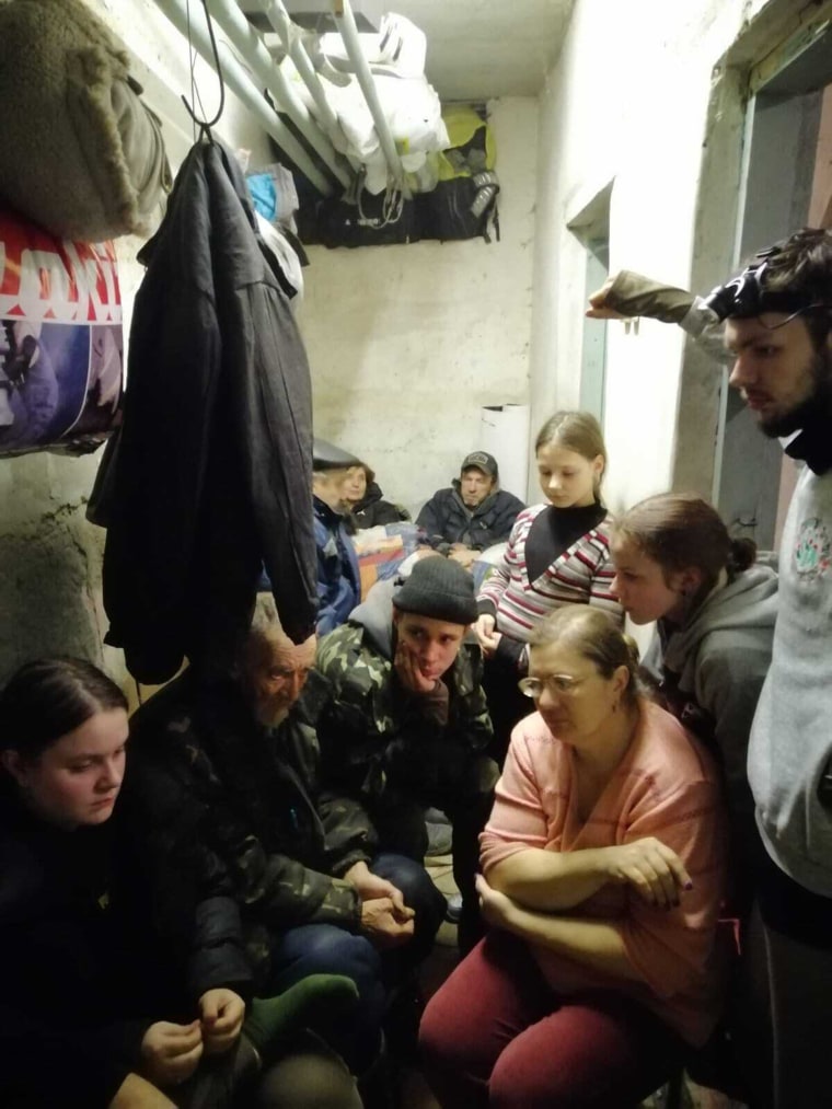 A family huddles together in the basement of the town's school. The citizens had to ration food and water in order to survive. At times, it was so hot they couldn't breathe. 