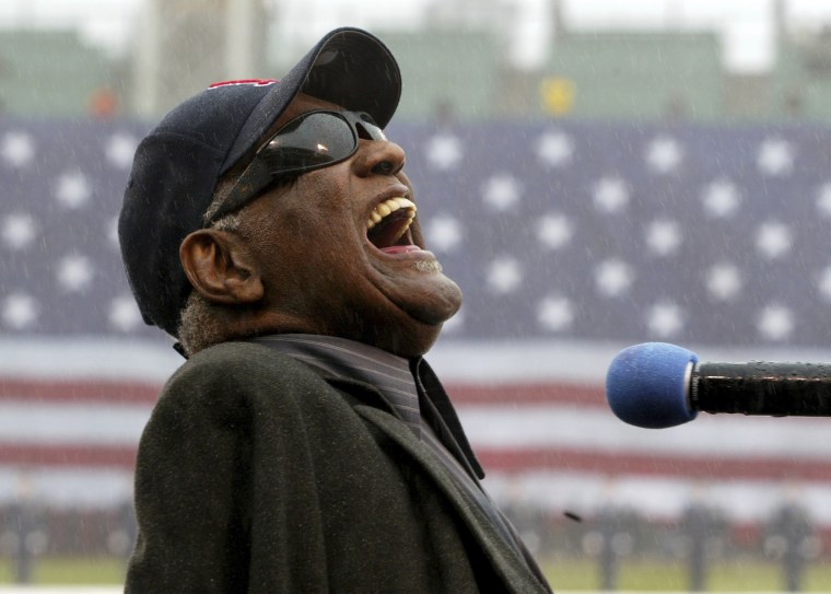 Ray Charles sings "America the Beautiful" in the rain at Fenway Park in Boston on April 11, 2003. Charles was posthumously inducted into the Country Music Hall of Fame in Nashville, Tenn., on Sunday along with The Judds. 