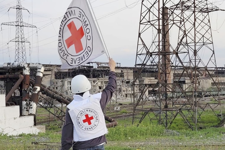 A long-awaited effort to evacuate civilians from the steel plant in the Ukrainian city of Mariupol was underway Sunday, as Red Cross officials were seen waving white flags near the scene.