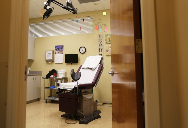 An examination room is seen at a women's reproductive health center