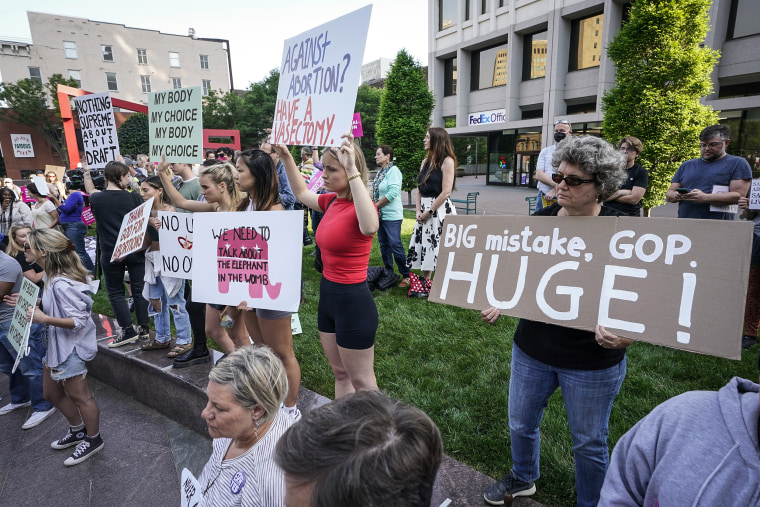Image: Protesters carry signs and listen to speakers as they demonstrate near a federal court on May 3, 2022, in Richmond, Va.