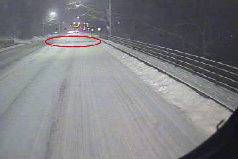 A forward-facing bus camera view shows the bridge deck separating at the east expansion joint (the red oval highlights the expansion joint) prior to its collapse in Pittsburgh on Jan. 28.