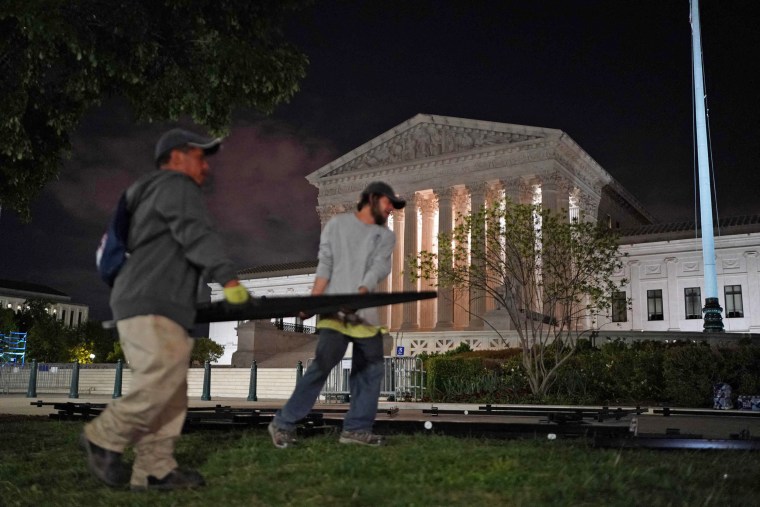 Workers install fencing around the Supreme Court in Washington on May 4, 2022.