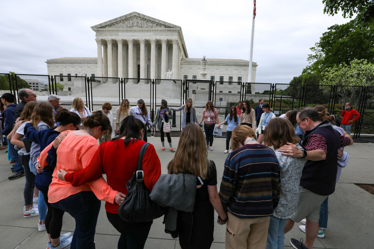 Pro-life demonstrators pray around the US Supreme Court in Washington