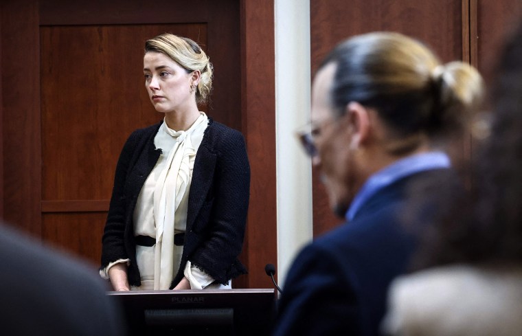 Image: UAmber Heard testifies as Johnny Depp looks on during a defamation trial at the Fairfax County Circuit Courthouse in Fairfax, Va., on May 5, 2022.